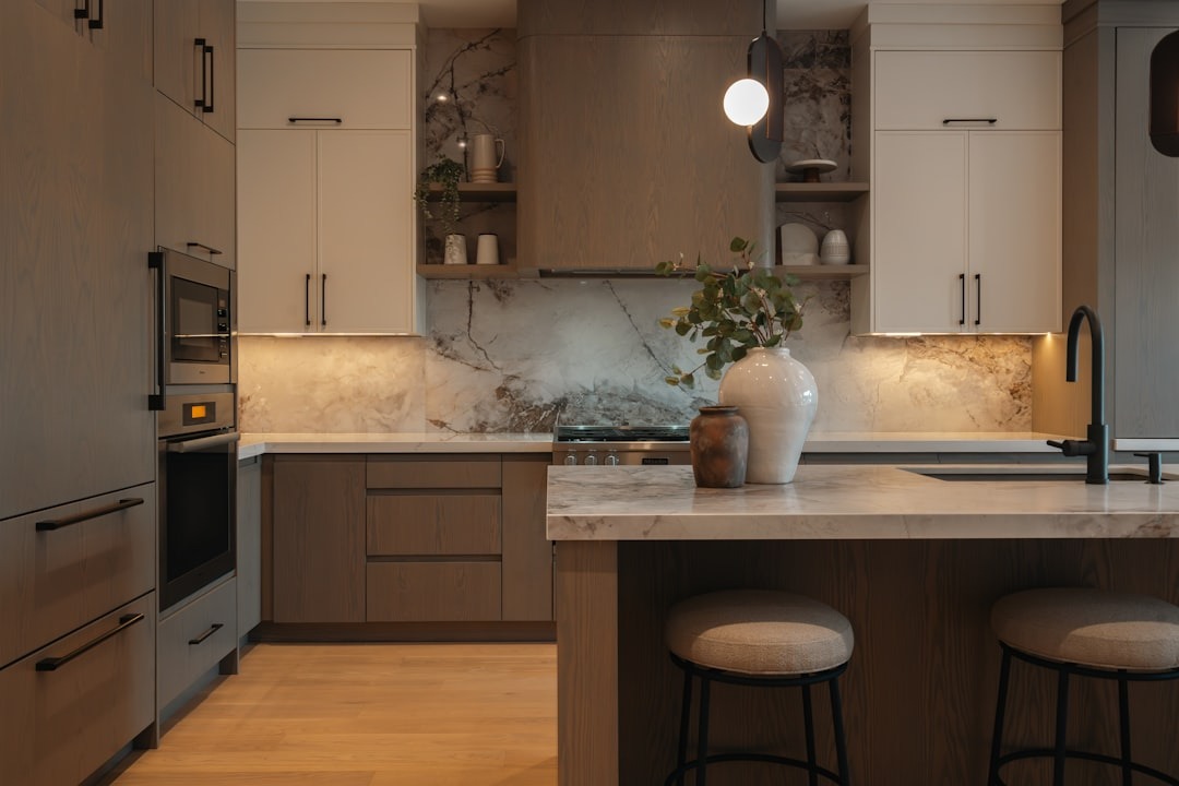 Modern kitchen with wood cabinets and a marble island.