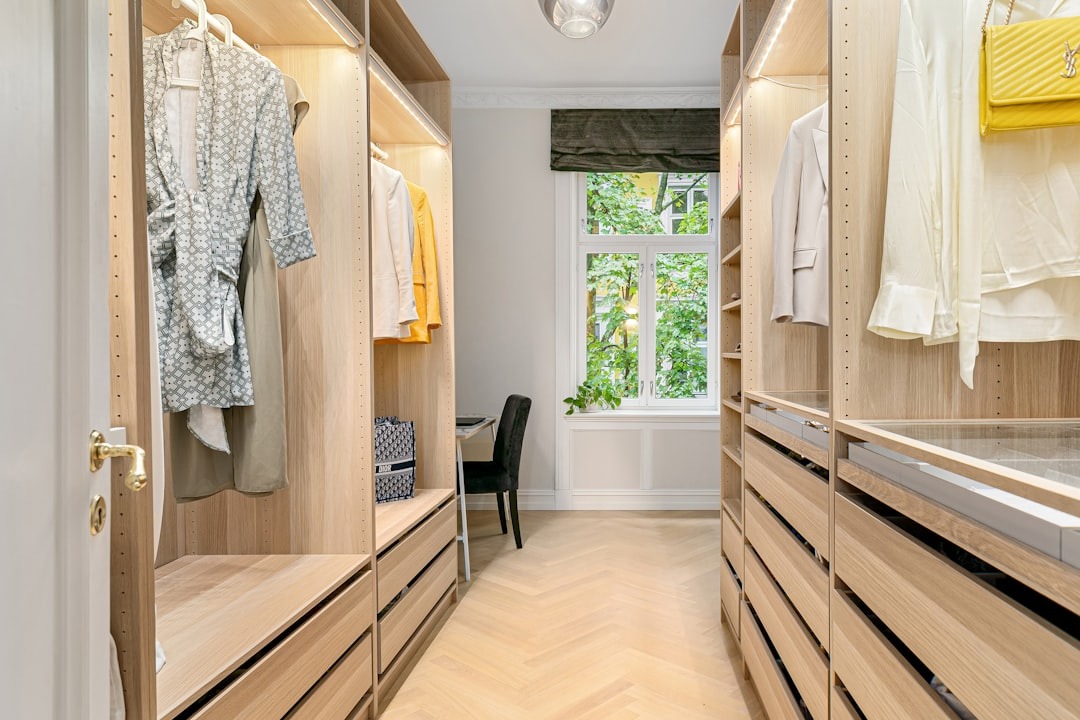 Modern walk-in closet with organized shelving and a small desk.